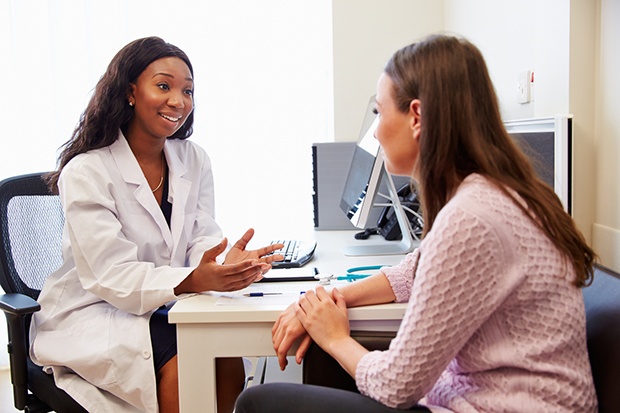 Woman Consulting with Physician