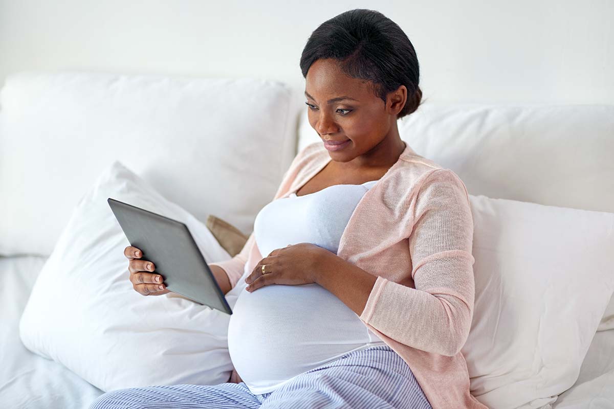 Woman reviewing information about pregnancy on a tablet