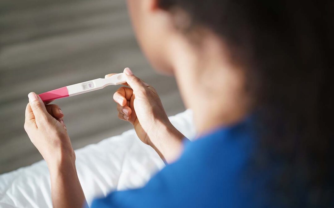 Woman looking at pregnancy test