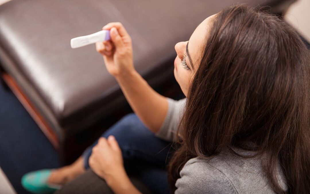 Woman viewing pregnancy test