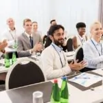 people applauding at business conference