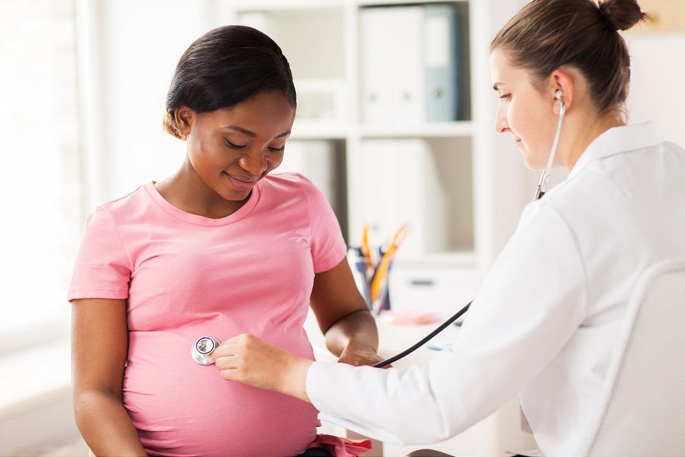 gynecologist doctor and pregnant woman at hospital Doctor examining pregnant woman